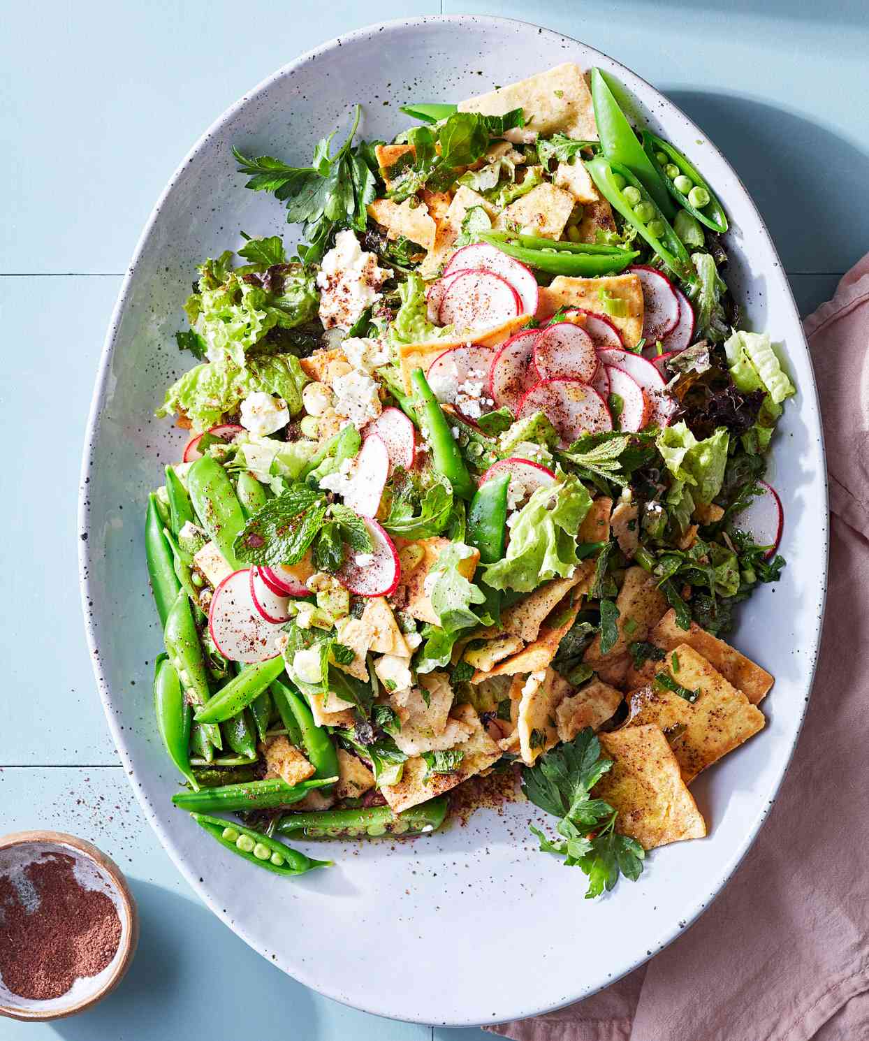 <p>Popular in Lebanon and Israel, fattoush is a crunchy, lemony salad of toasted pita, herbs and vegetables. This  quick version showcases spring vegetables like snap peas and radishes. It's seasoned with sumac, which has a distinctly sour, earthy flavor. Find it in Middle Eastern markets or online.</p>
                          