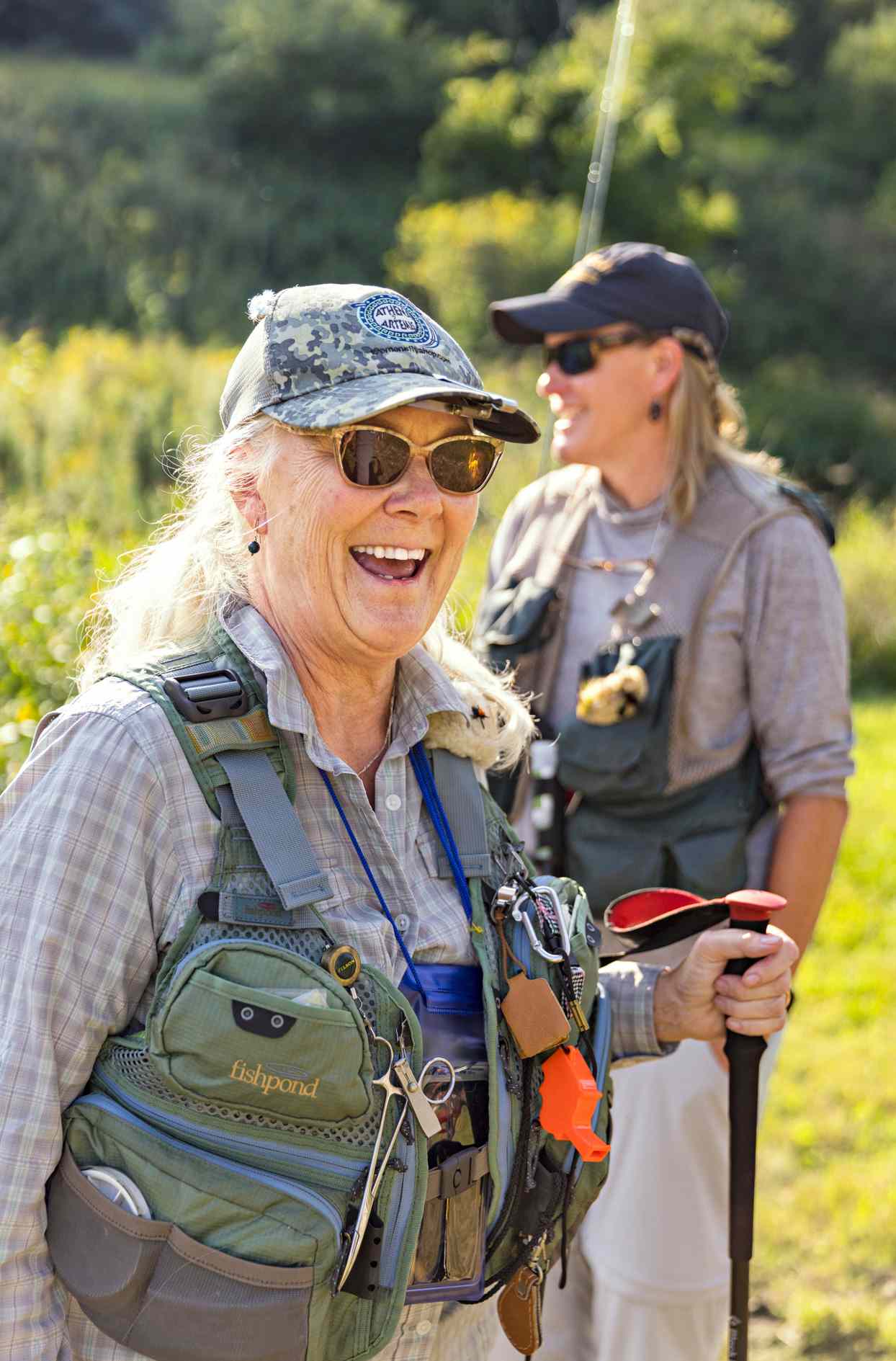 woman fly fisher smiling wearing gear