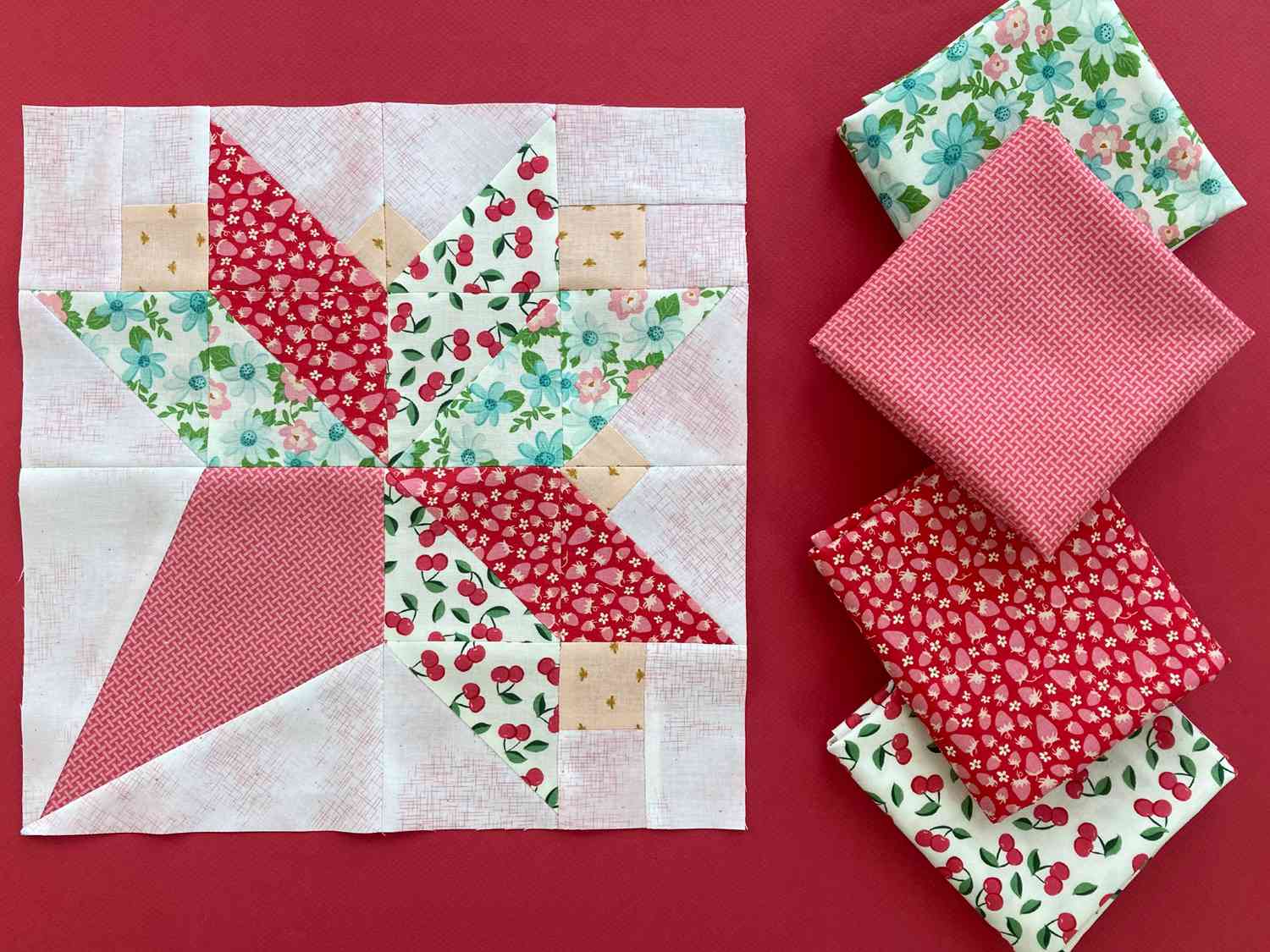 Bouquet block made with floral and fruit fabric on a red background.