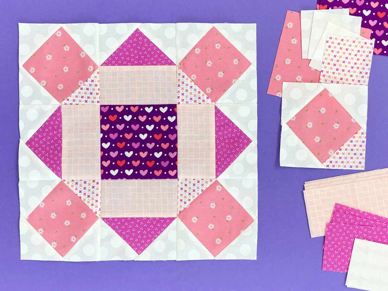 Block 9 made with purple, coral, and pink hearts fabric