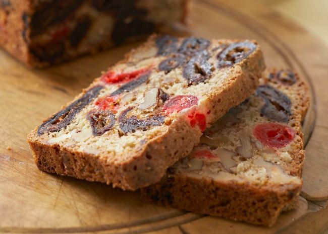 closeup of slices of fruitcake with dates and candied cherries