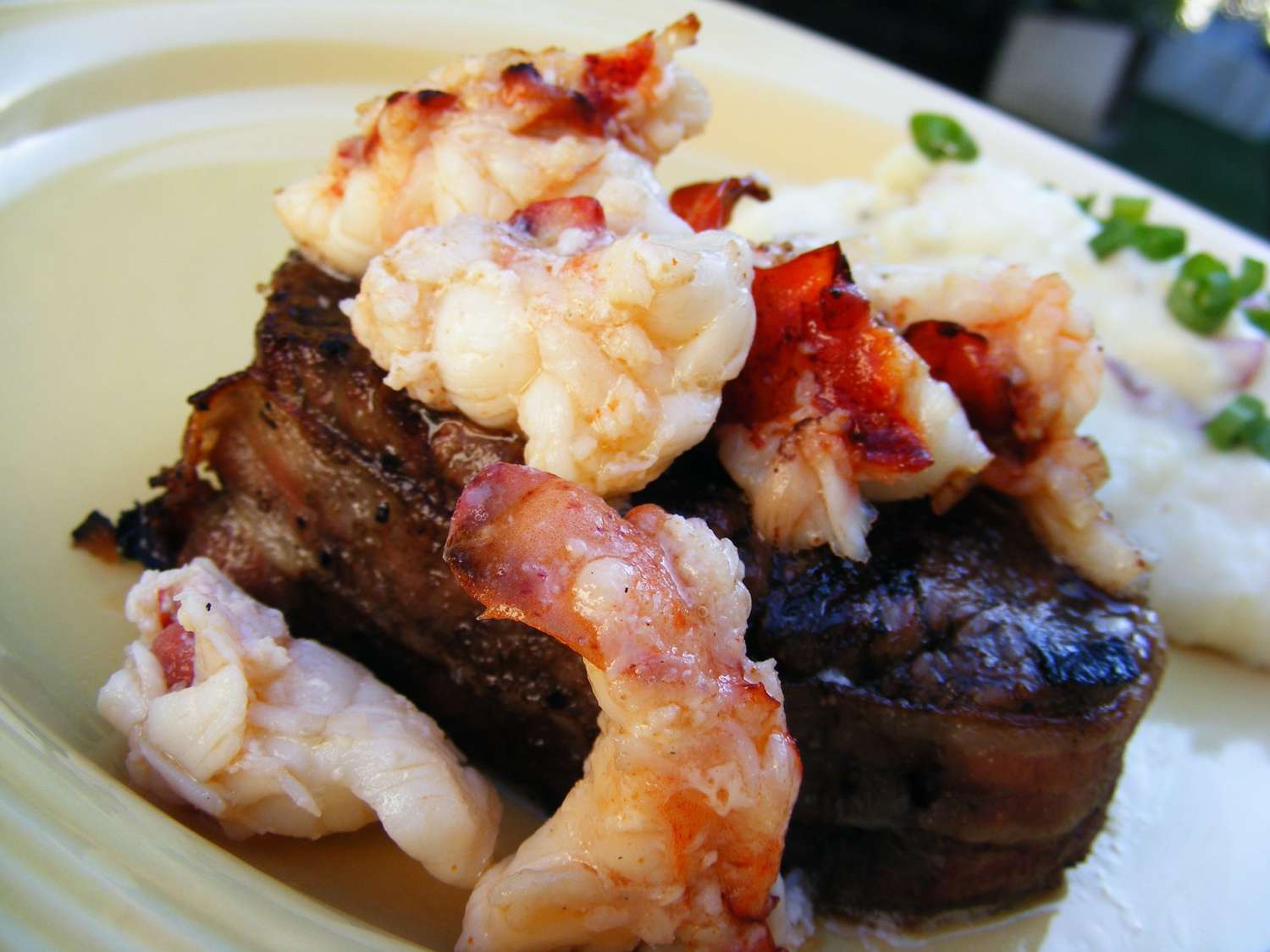 closeup of a filet mignon topped with lobster tail
