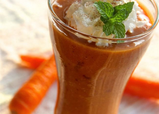 Carrot Cake Smoothie with whipped cream and mint in clear glass