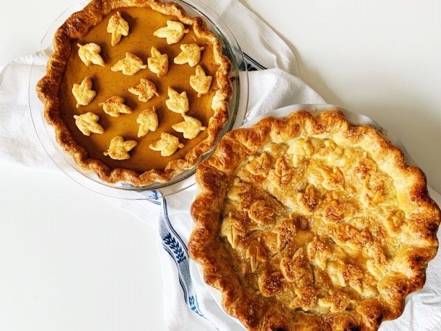 pumpkin pie and apple pie topped with pastry leaf cutouts