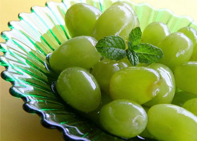 closeup of green grapes with a sprig of mint