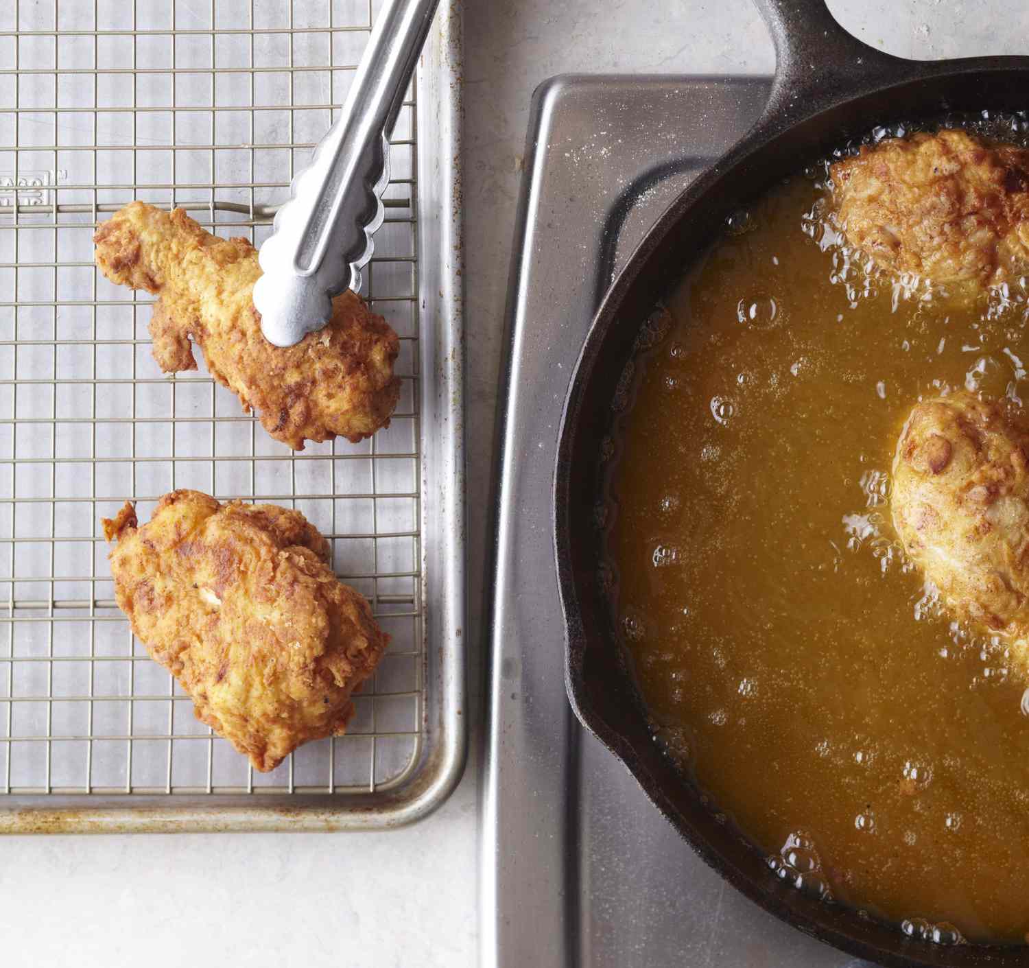 Fried Chicken From Oil to Rack with Tongs