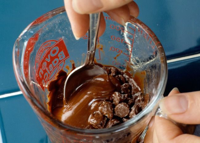 stirring chocolate melted in a glass measuring cup
