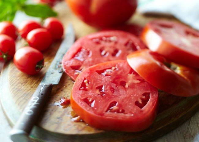 Sliced tomato on cutting board