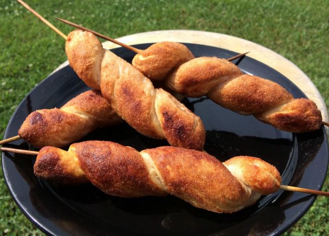 cinnamon sugar biscuits cooked on skewers over a campfire