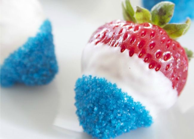 white chocolate-dipped strawberries dipped in blue sprinkles so they're red, white, and blue
