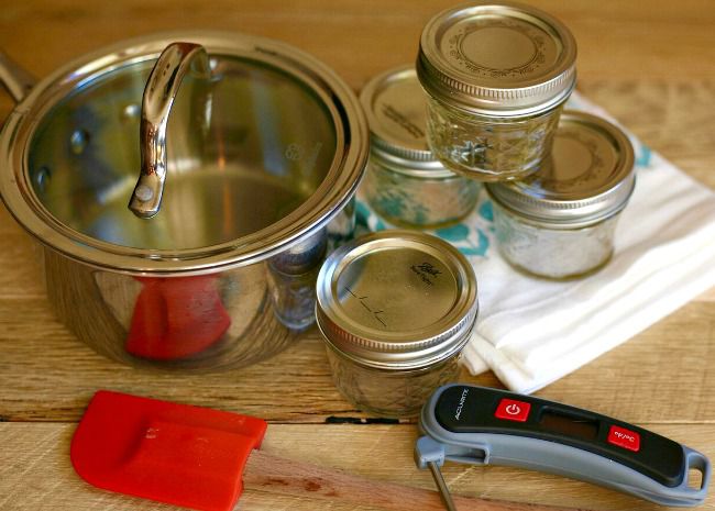 Saucepan, jars, thermometer, and spatula