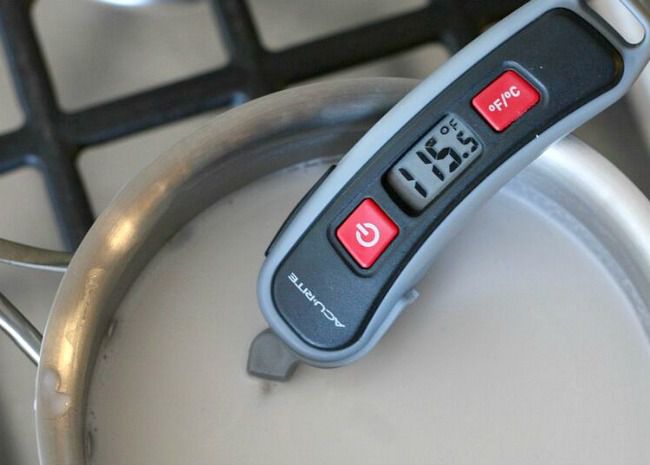 Use thermometer to check milk temperature