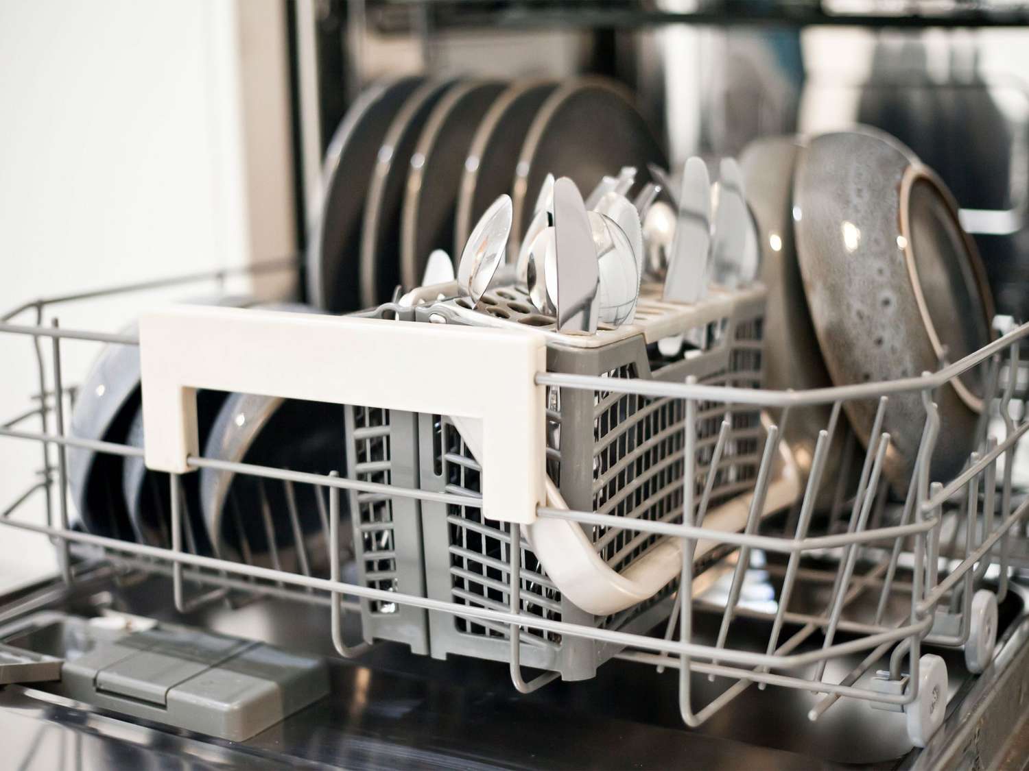 Dishwasher bottom rack loaded with clean dishes