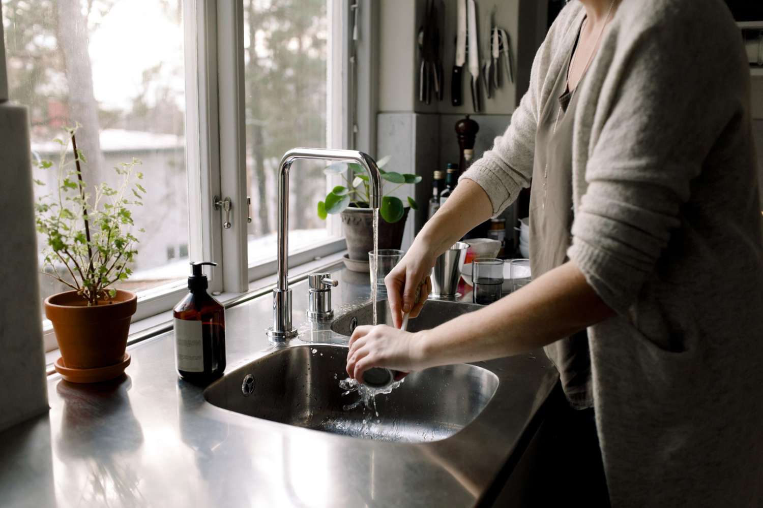Woman Washing Dishes at Sink