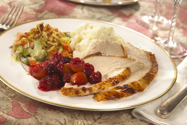 plate of turkey, cranberry sauce, mashed potatoes, green side