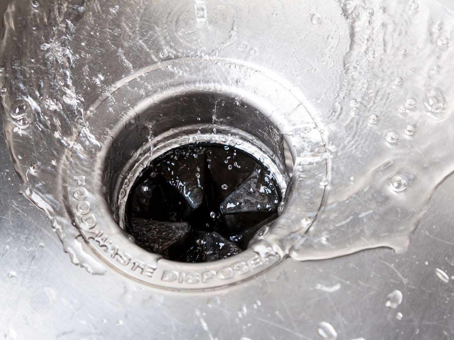 Garbage disposal in sink flushed with water