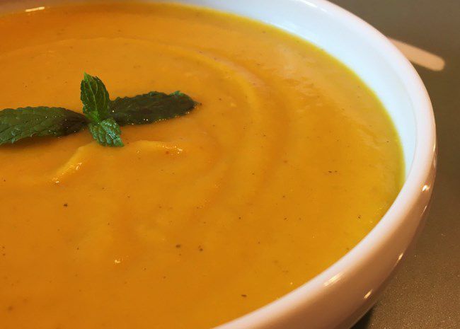 closeup of a bowl of creamy-looking squash soup