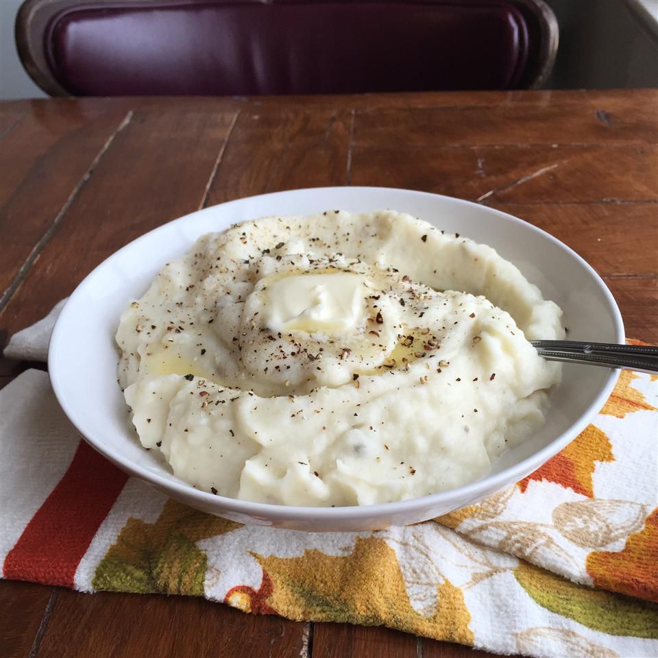 white bowl of mashed potatoes on a table