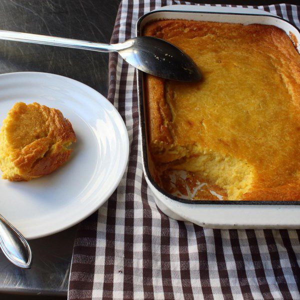 Chef John's Creamy Corn Pudding in a casserole dish and on a plate