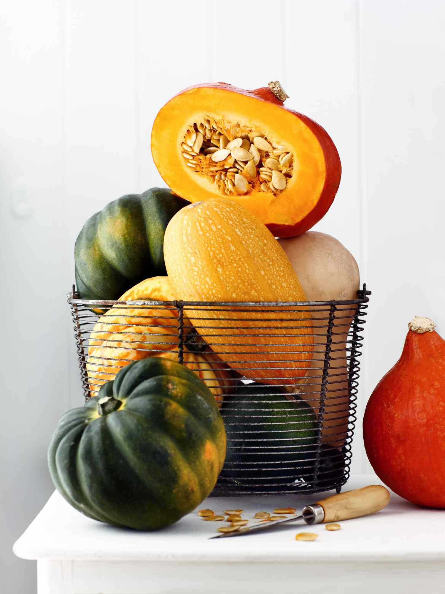 Variety of squashes on sideboard one cut open