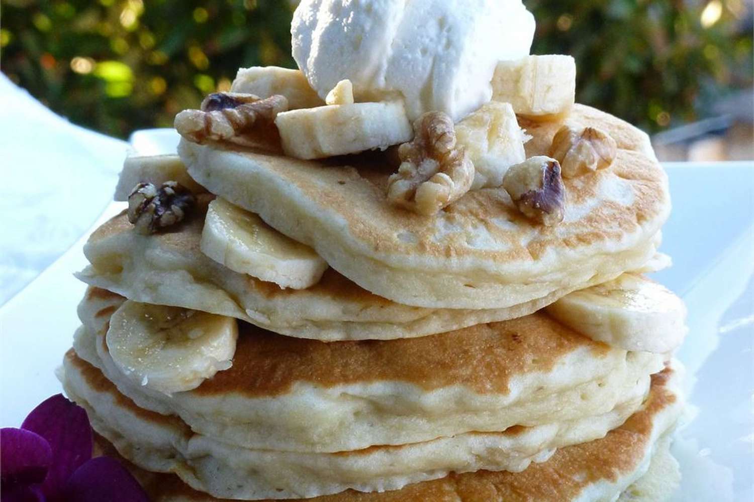 Banana pancakes stacked with whipped cream