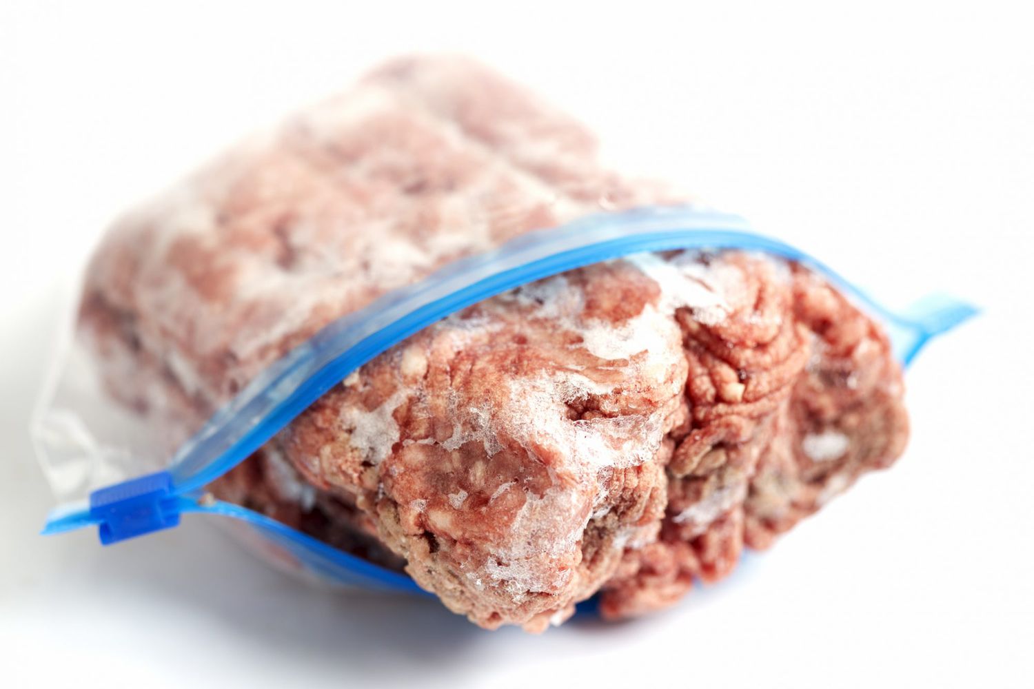 frozen block of ground beef in a plastic ziplock bag