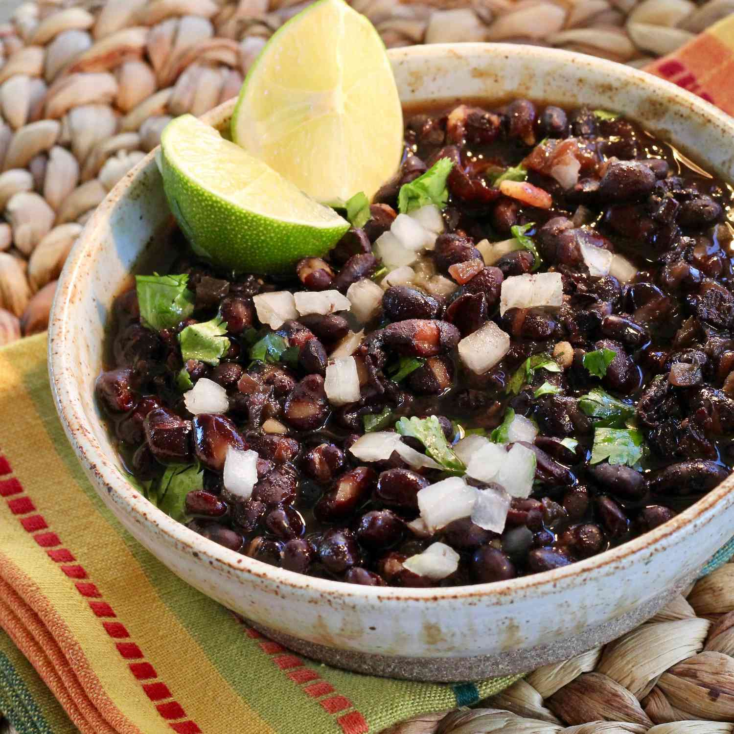 Black beans in a bowl with a lime garnish