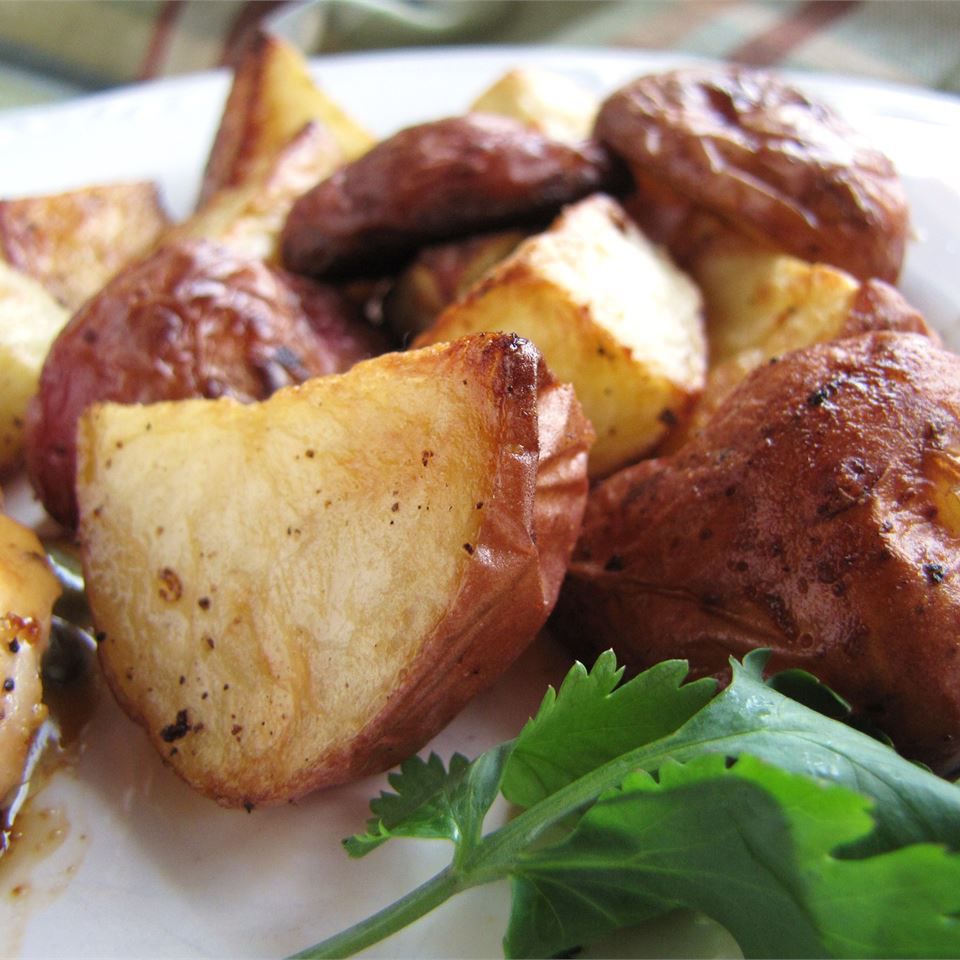Roasted New Red Potatoes with garnish on a white plate