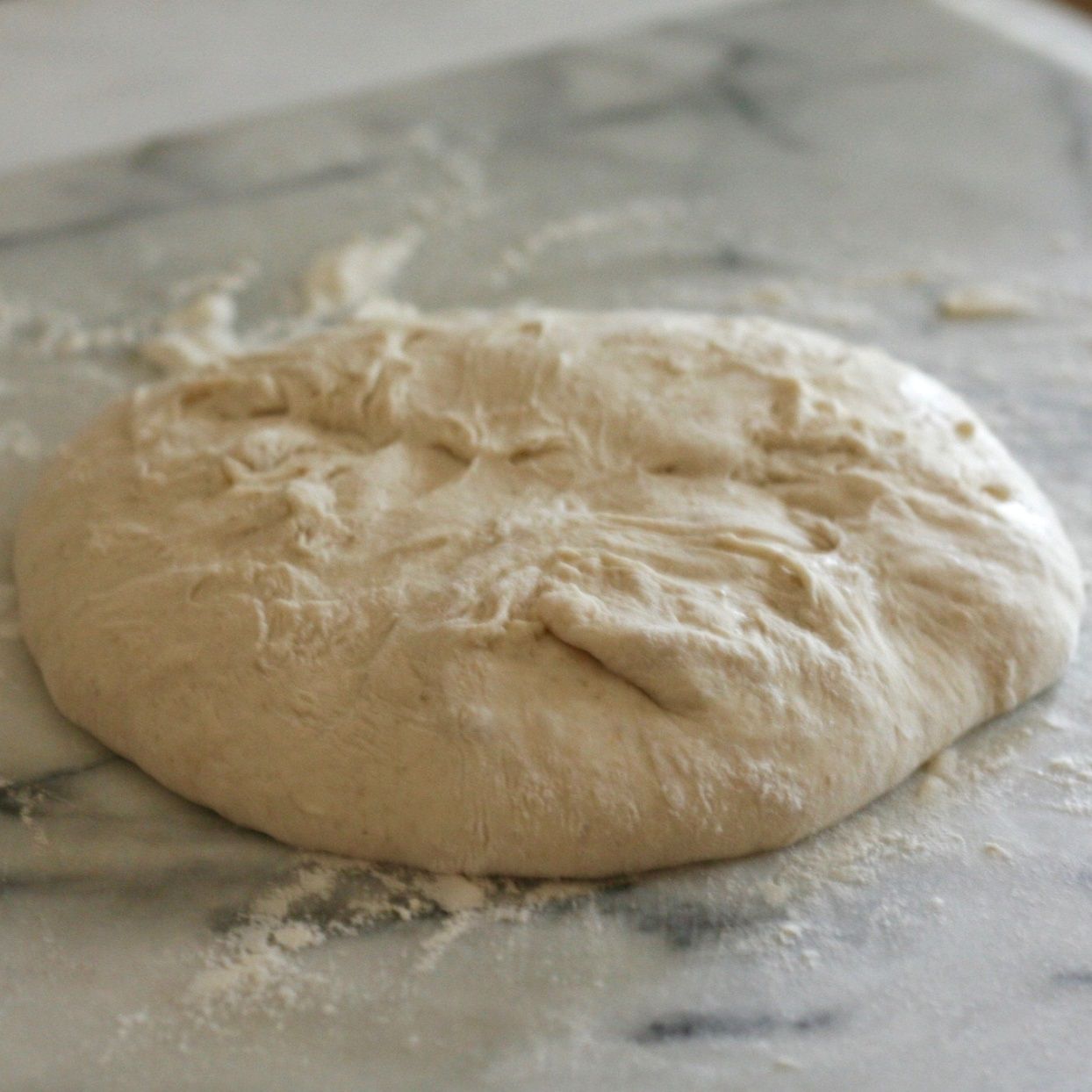 sourdough bread dough on floured countertop