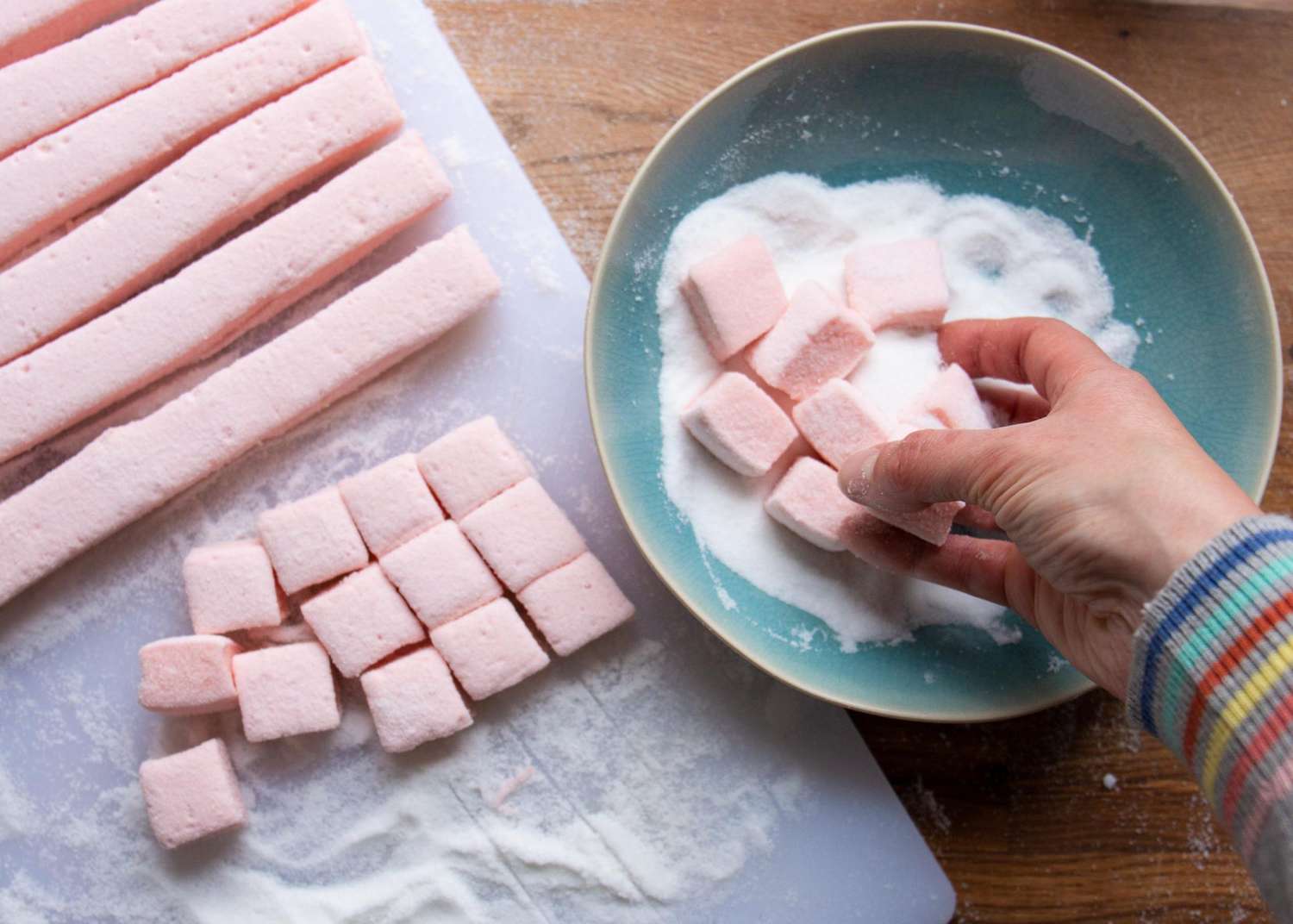 tossing marshmallows in sugar