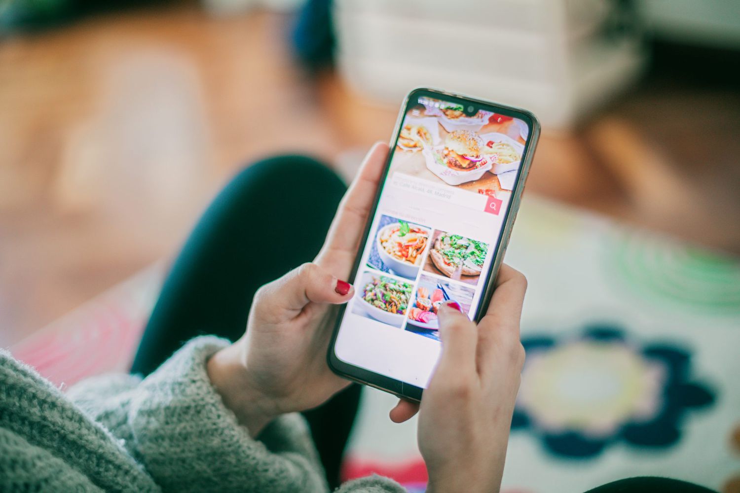 Woman using meal delivery service through mobile app.