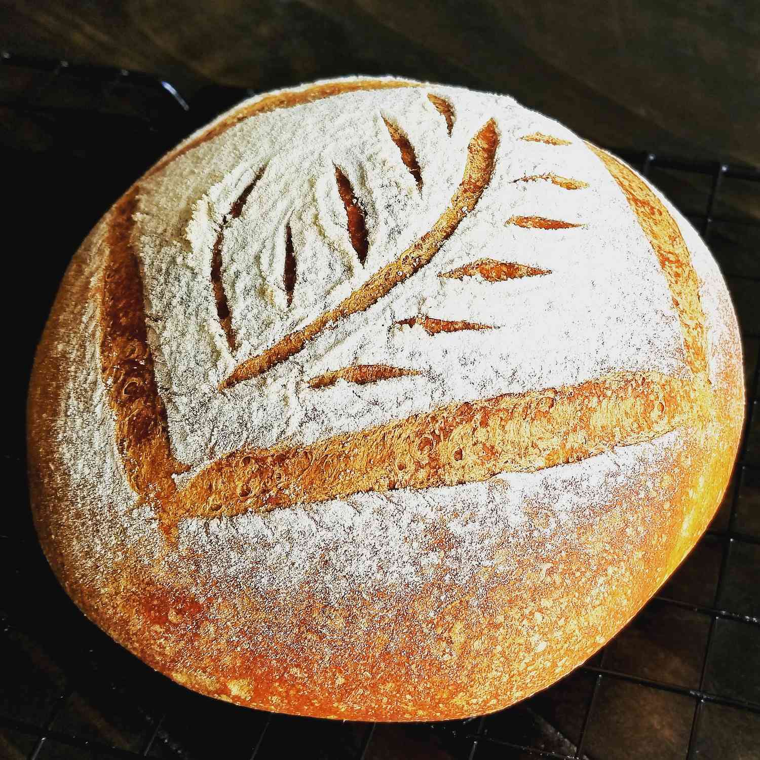 a boule of yeast bread with a decorative score on top