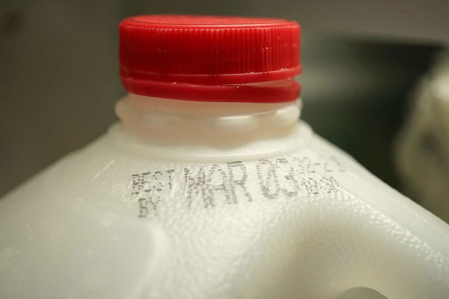 close up of best by date on jug of milk