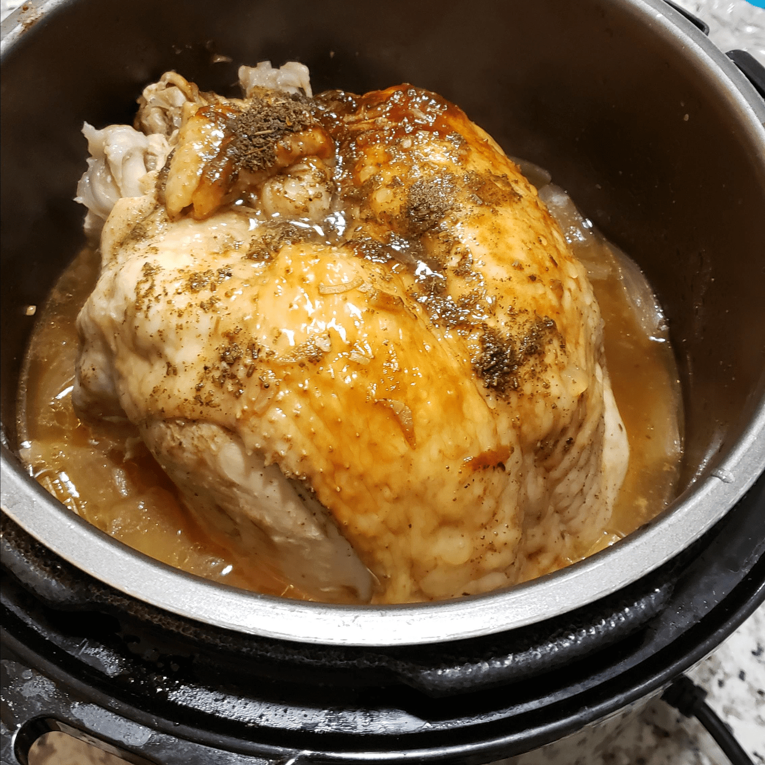 turkey breast in an Instant Pot sprinkled with seasoning and herbs