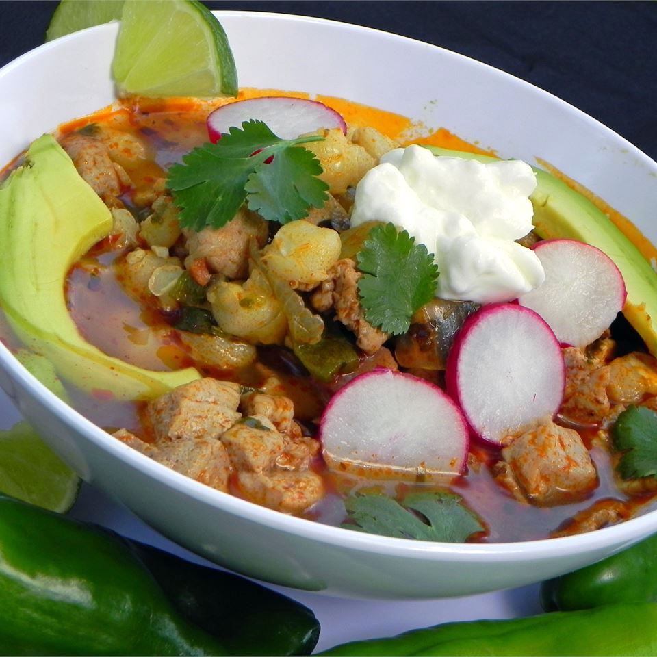 bowl of Posole with avocado and radishes for garnish