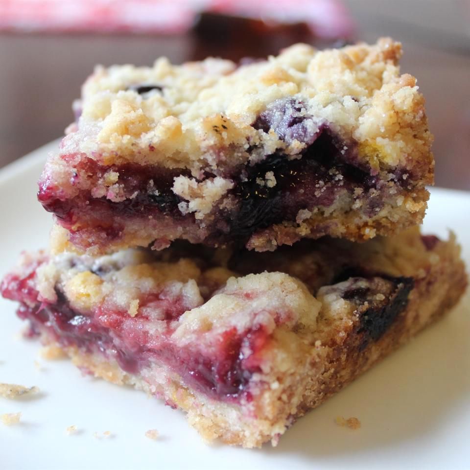 two Blueberry Crumb Bars on a white plate