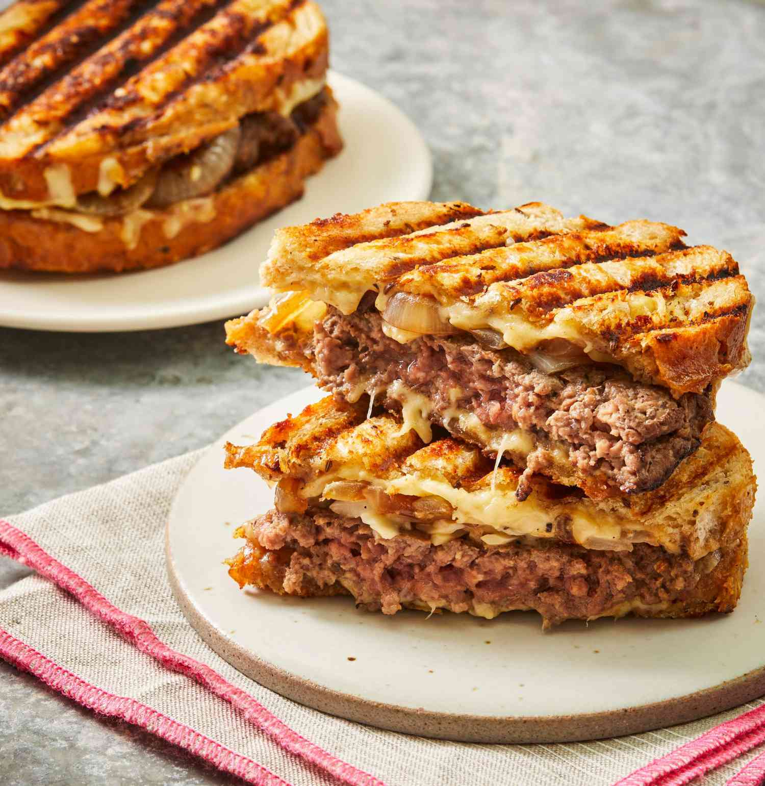 Close-up on 2 halves of a patty melt, stacked