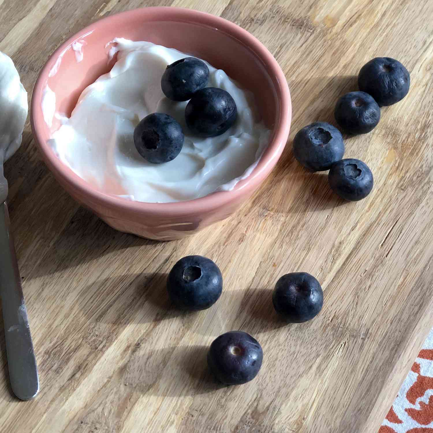 creamy-looking yogurt in a ramekin with fresh blueberries