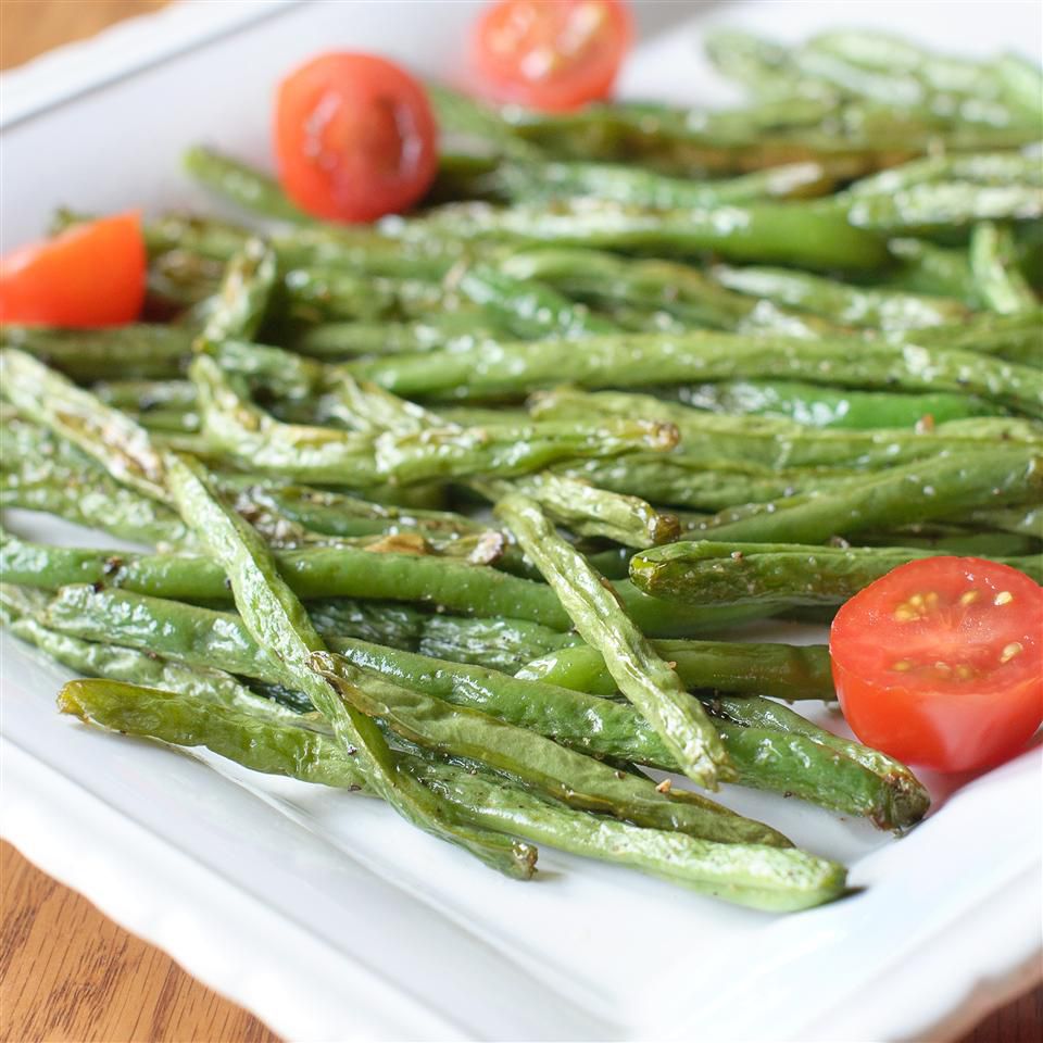 Roasted Green Beans with tomatoes on a white plate