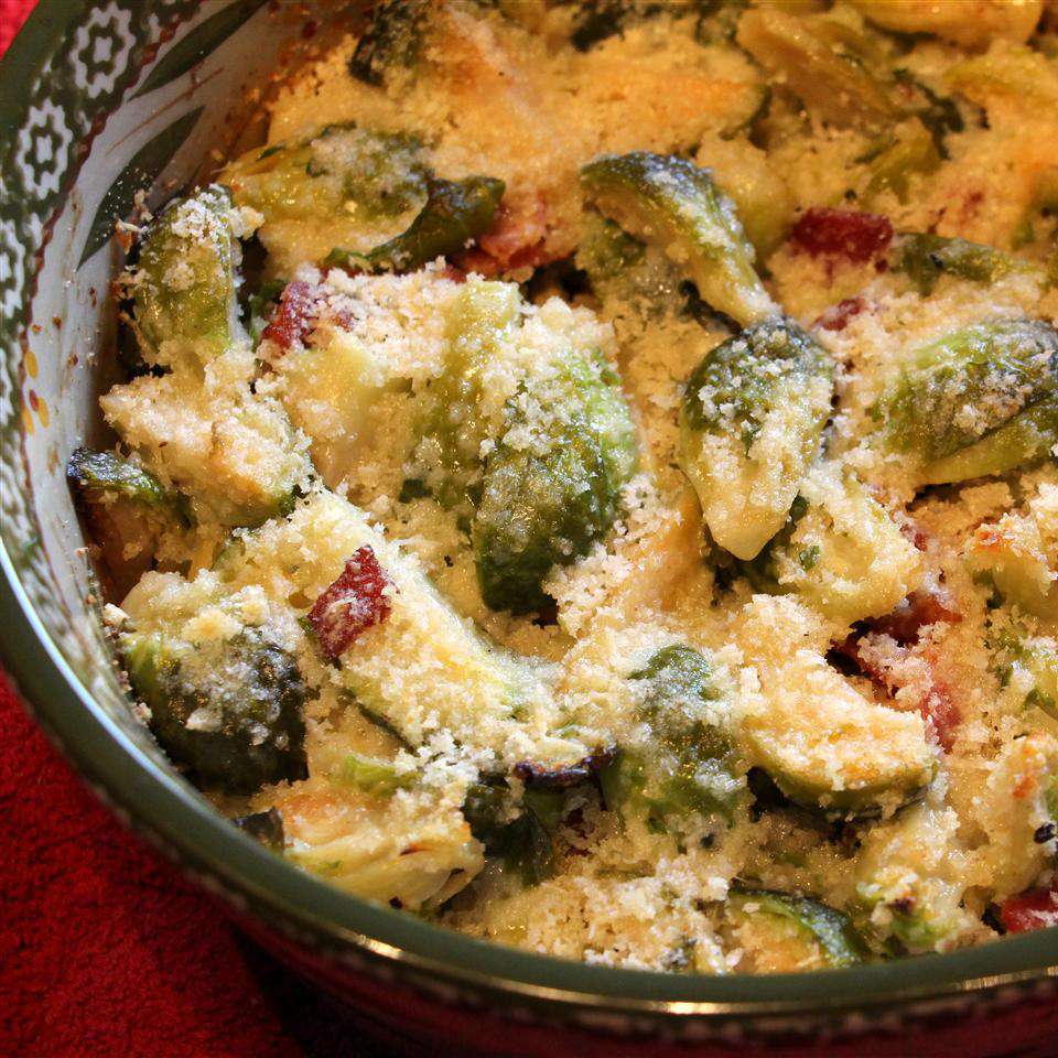 Brussels Sprouts Gratin in a bowl on a red surface