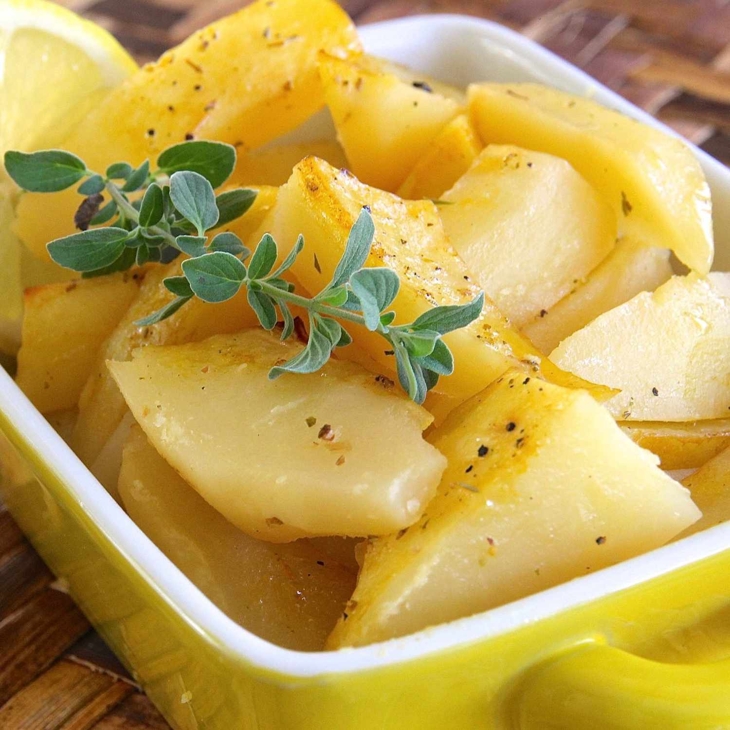 Greek-Style Lemon Roasted Potatoes in a yellow dish