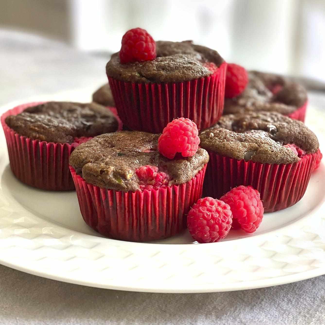 Platter of chocolate zucchini cupcakes with fresh raspberries