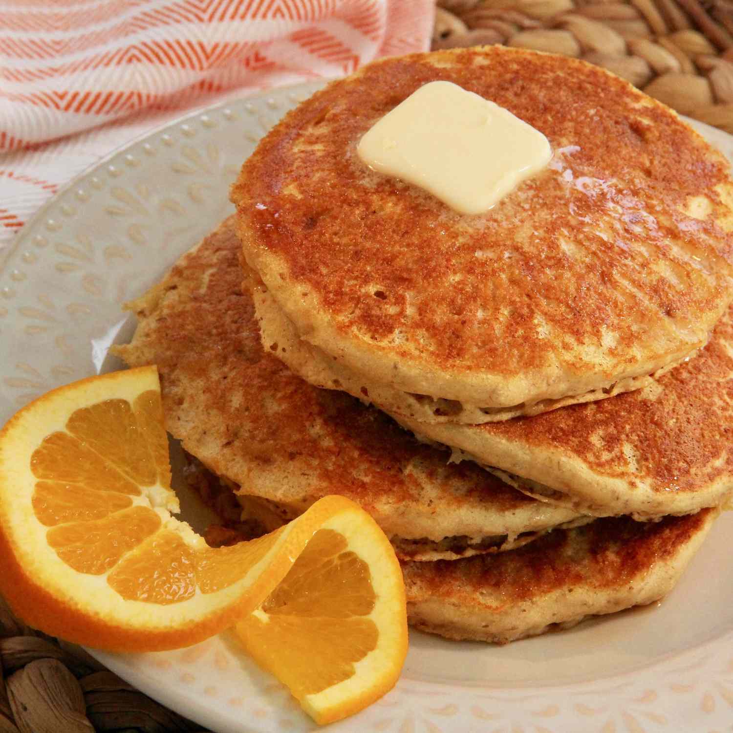 Orange Pancakes on a plate with an orange twist