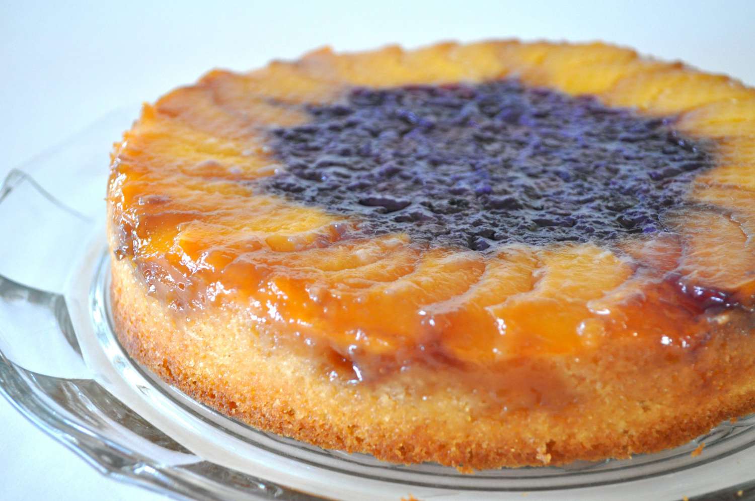 Sliced peaches around the outside, with blueberries in the center, this cake looks like a giant sunflower