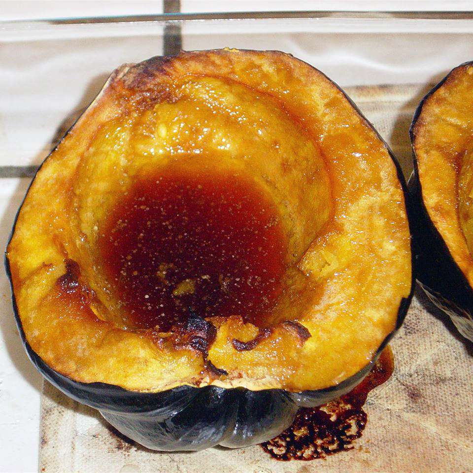a roasted acorn squash half filled with melted brown sugar and butter