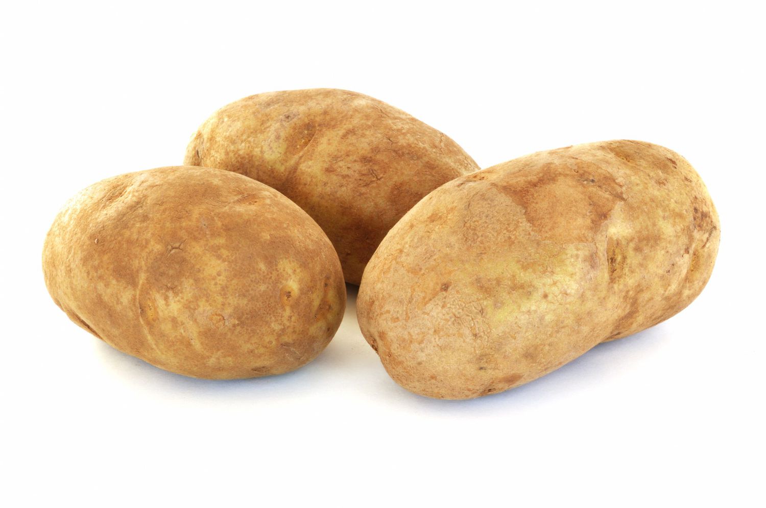 Three Raw Russet Potatoes