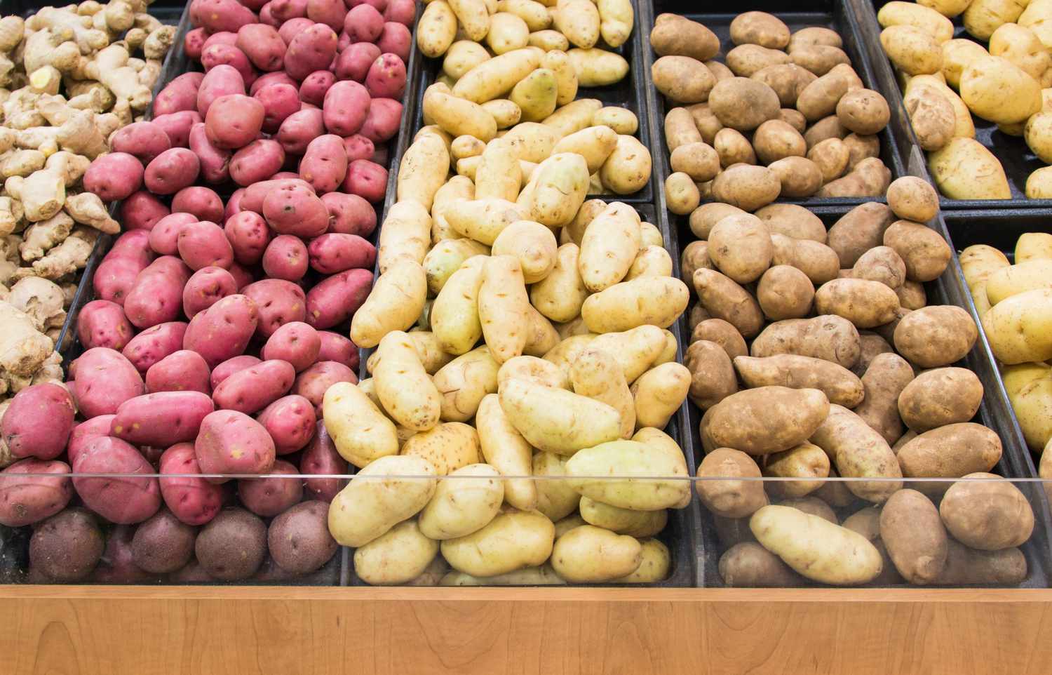 Different colors and varieties of potatoes in a grocery store