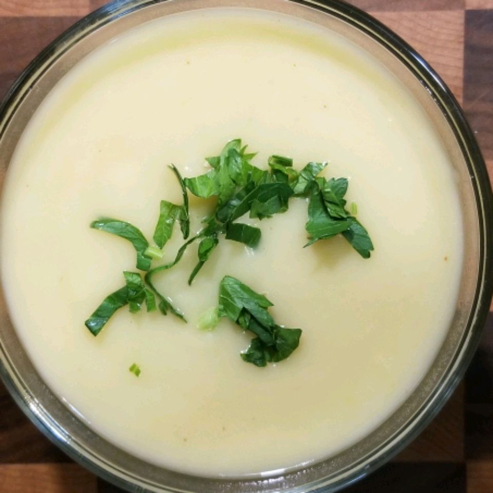 potato soup in a grey bowl with a parsley garnish