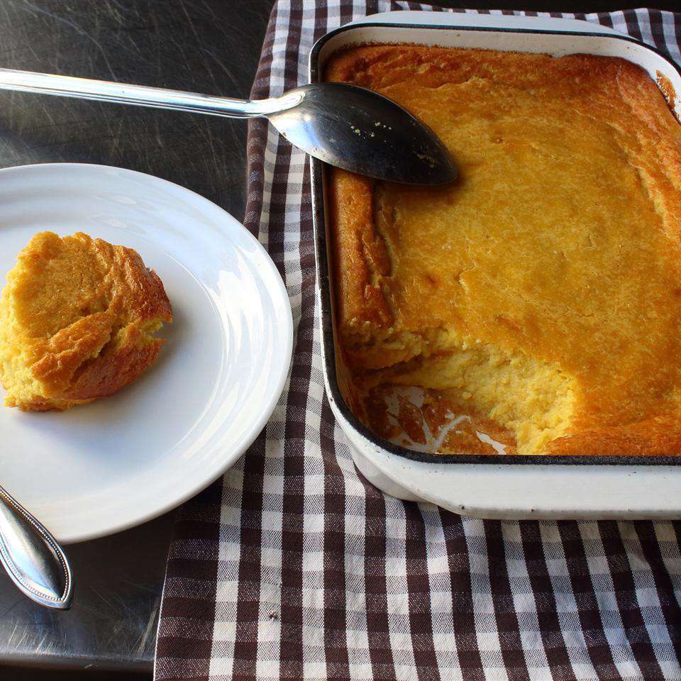 casserole dish of corn pudding and a serving on a plate