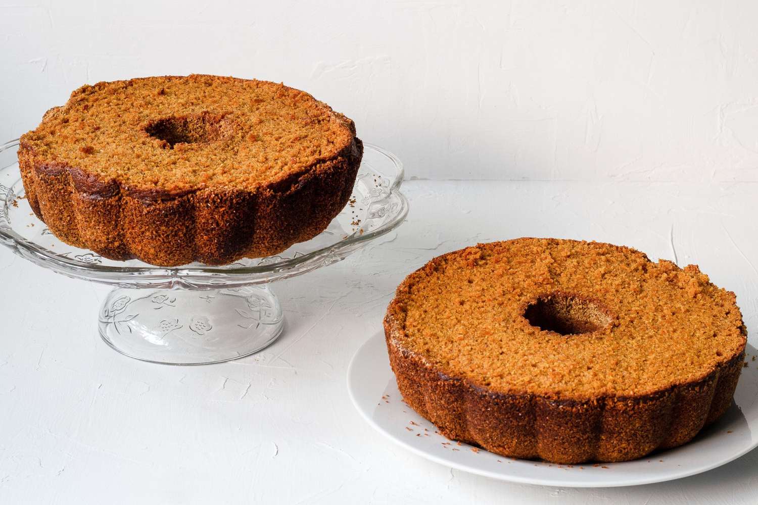 two pumpkin-shaped bundt cakes with flat sides trimmed